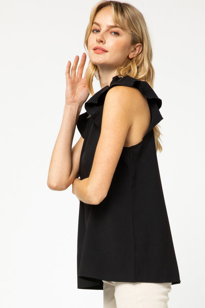 Side view of ruffle sleeve top in black with good length for longer torsos.