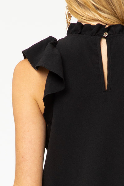 Close back view of ruffle sleeve and neck with keyhole closure in black.