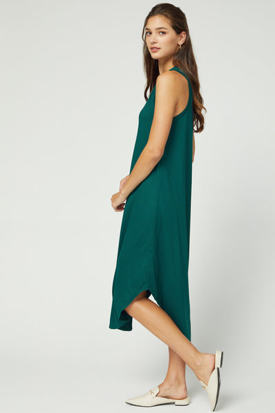 Full length side view of sleeveless midi dress with hi-lo hem in hunter green color.