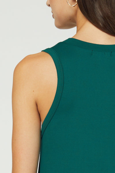 Up close back view of arm hole and neckline on midi dress in hunter green.