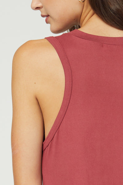 Up close view of slight cut in shape of sleeveless midi in marsala.
