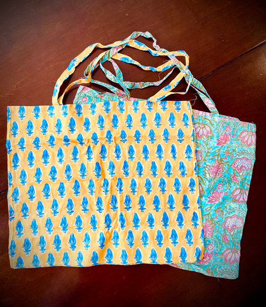 Reusable grocery bags foldable. Yellow with blue flowers pattern. Aqua with pink flowers pattern.
