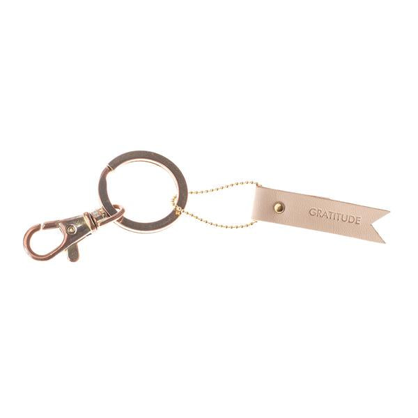 Leather hang tag used as keychain with message stamped on leather.