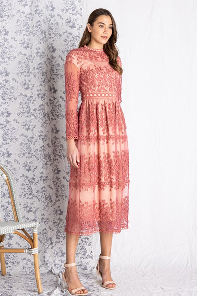 Full view of Women's dresses for wedding guest or bride. Dusty rose colored crocheted lace midi paired with nude heels.