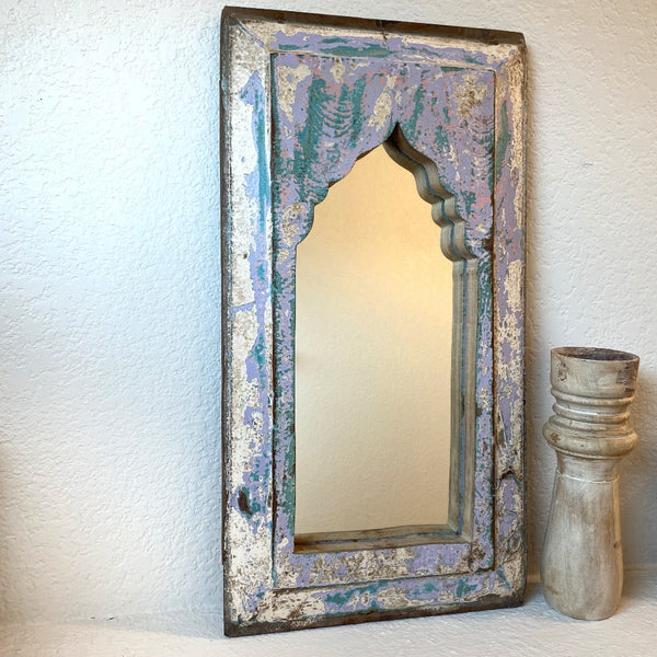 White and pastel colored decorative wooden mirror.