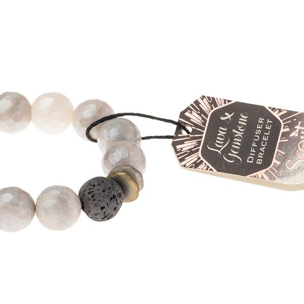 Essential oils diffuser bracelet close up of lava diffuser bead on champagne gemstones.