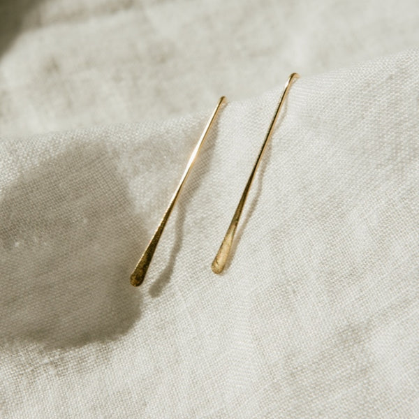 Close up of Minimalist Style Gold Earrings for Women in 14k gold.