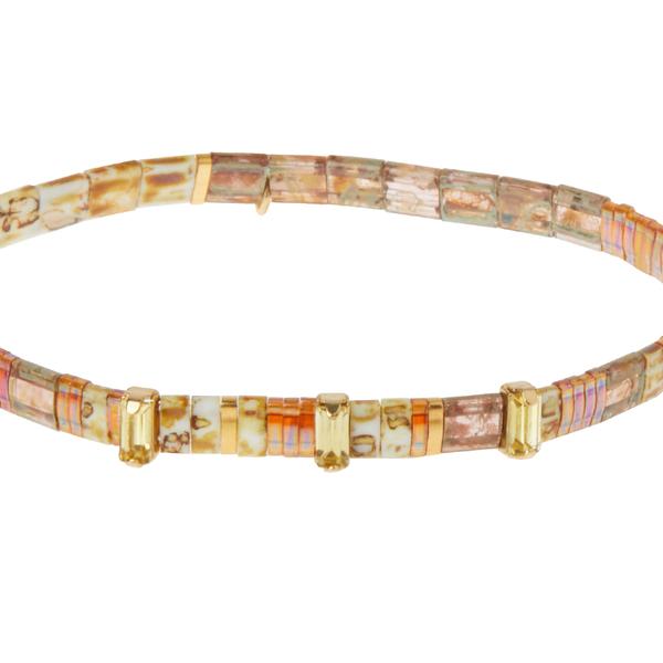 Tortoise shell bracelets with rhinestones and gold charm.
