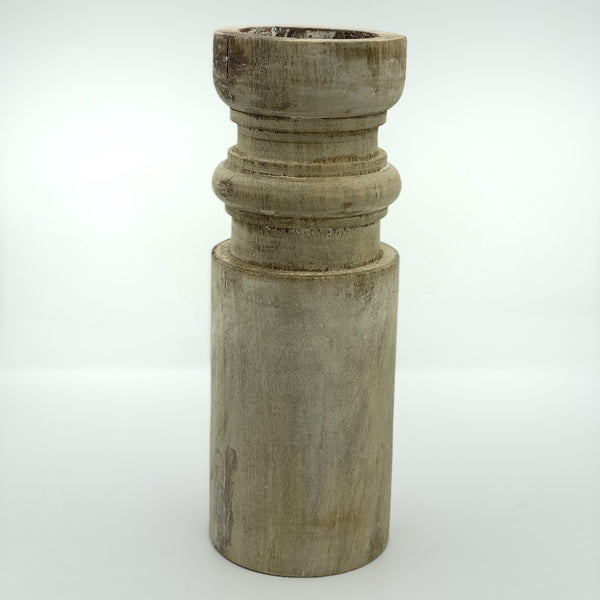 Pillar candle holder tall in barrel shape.