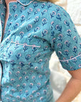 Block print pajama set in aqua with small floral pattern.