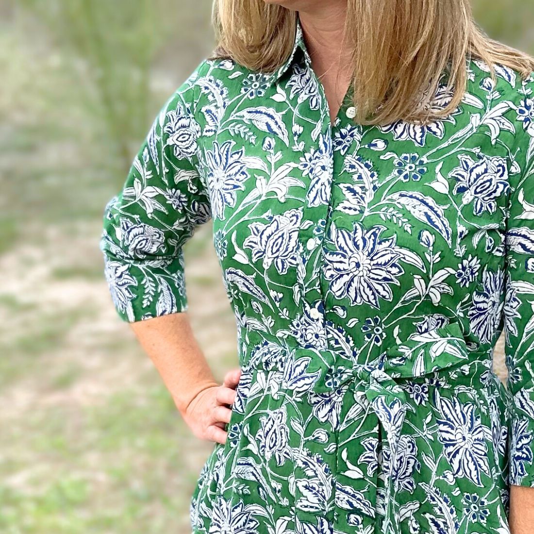 Green dahlia floral cotton day dress close up of front.