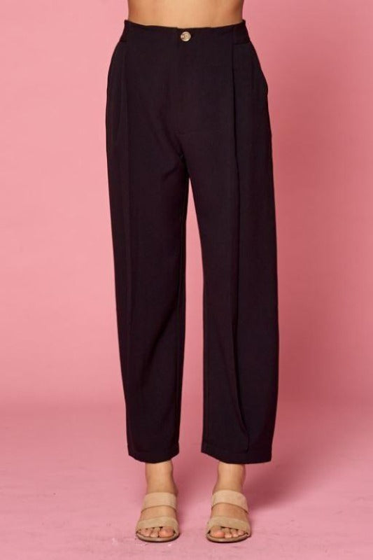 Women&#39;s pleated black slacks. Wide legs and button and zip front closure with elastic back waist.