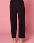 Women's pleated black slacks. Wide legs and button and zip front closure with elastic back waist.