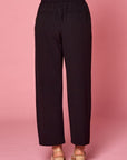 Back view of women's pleated black slacks with faux back pockets and back elastic waist.