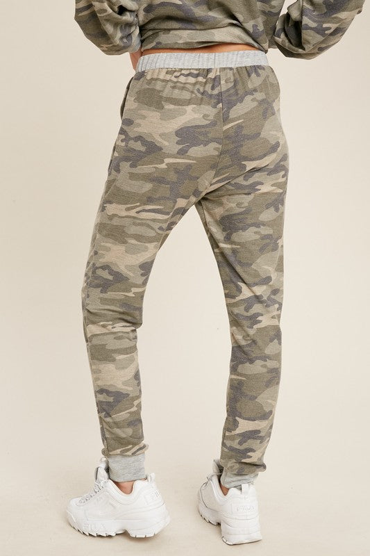 Back view of loose fit women&#39;s camo joggers with drawstring waist and pockets.