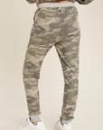 Back view of loose fit women's camo joggers with drawstring waist and pockets.