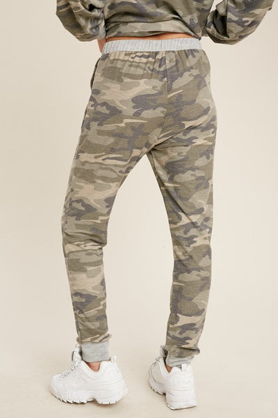Back view of loose fit women's camo joggers with drawstring waist and pockets.