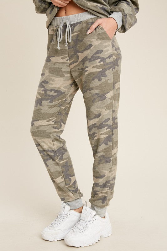 Women&#39;s lightweight camo jogger pants with grey cuffs and drawstring waist. Pockets.