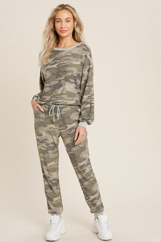 Women's camo long sleeve top paired with matching camo jogger pants.