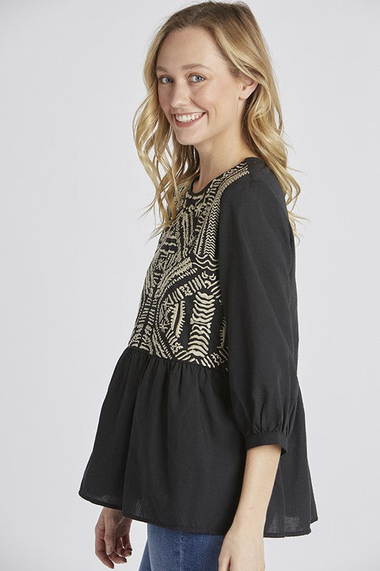 Side view of Women&#39;s embroidered peasant top. - Black with half sleeves and peplum cut.