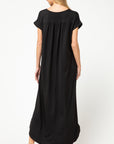 Back view of black knit maxi with pleating at back yoke..