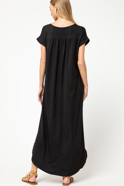 Back view of black knit maxi with pleating at back yoke..