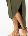 High low rounded hem on olive maxi.