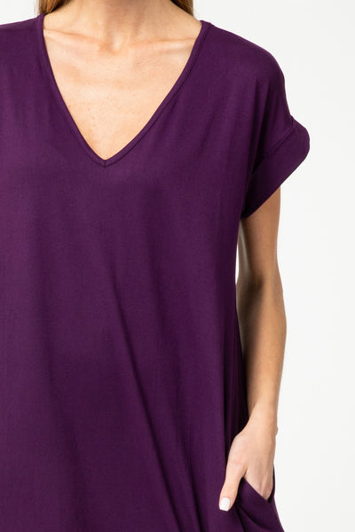 Plum knit maxi closeup of v-neck and rolled short sleeves.