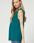 Side view of teal sleeveless blouse with good length for coverage.