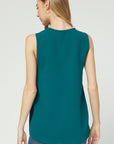 Back view of teal sleeveless blouse with good coverage length.