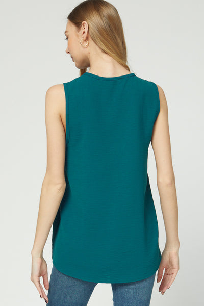 Back view of teal sleeveless blouse with good coverage length.