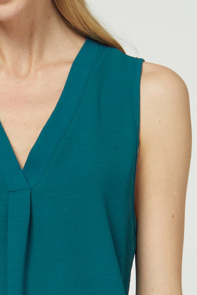 Close up view of sleeveless v-neck blouse with pleated placket at front.
