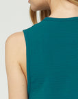 Close up of back neckline of sleeveless teal blouse.