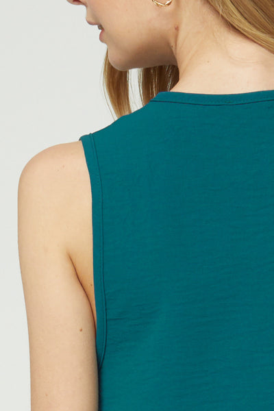 Close up of back neckline of sleeveless teal blouse.