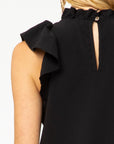 Close back view of ruffle sleeve and neck with keyhole closure in black.