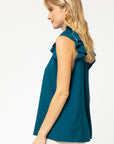 Side view of teal ruffle sleeve blouse with good coverage length.