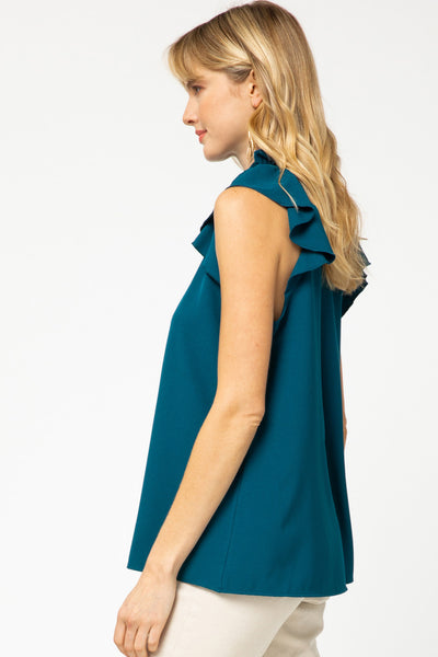 Side view of teal ruffle sleeve blouse with good coverage length.