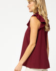 Side view of ruffle sleeve burgundy blouse with good length for long torsos.