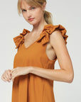 Side view of camel colored v-neck sleeveless top with ruffle strap.