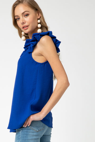 Side view of royal blue ruffle strap sleeveless top. Great length for coverage.