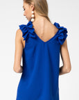 Back view of royal blue top for fall with back v-neck and ruffle sleeveless strap.