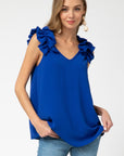 Fall fashion 2020. Royal blue sleeveless top with beautiful ruffle accents on straps. V-neck.