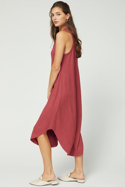Side view of sleeveless midi in marsala color with rounded hi-lo hem.