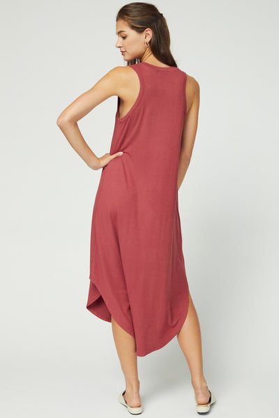 Back view of longer back hemline and sleeveless cut with slight cut in/racerback shape in color marsala.