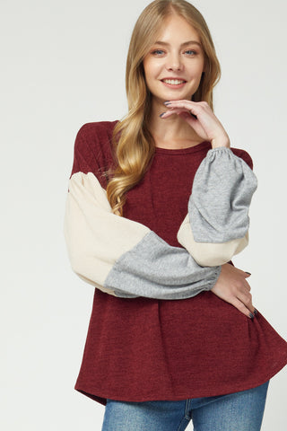 Women's sweaters 2020. Lightweight burgundy bodice with cream and grey color blocked puff sleeves.