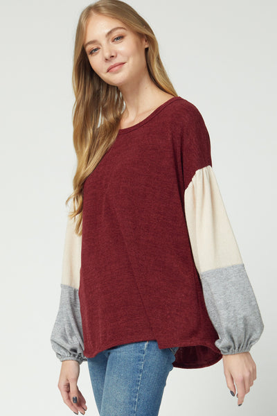Women's sweaters 2020 with rounded neck and color blocked puff sleeves. Rounded hem with longer length for good coverage.