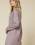 Side view of heathered sweater dress with banding at hem and long sleeve cuffs.