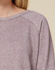 Close up view of round neck sweater dress in heathered knit material.