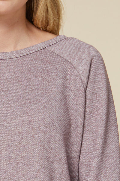 Close up view of round neck sweater dress in heathered knit material.