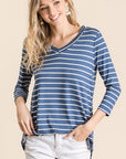 V-neck 3/4 sleeve women's tunic in blue with white stripe paired with light colored denim.